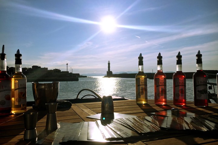 a close up of a beer bottle and a glass of water