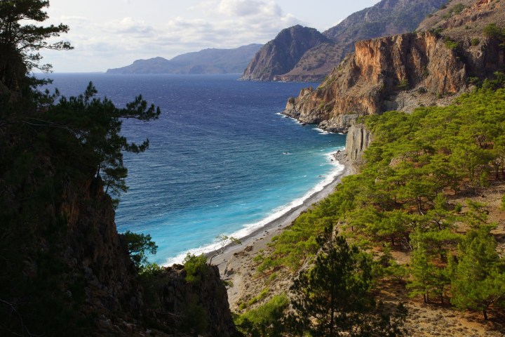 a body of water with a mountain in the background