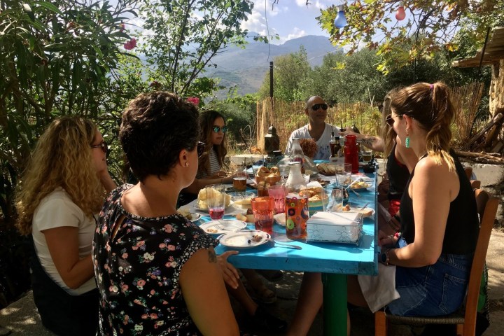 a group of people sitting at a picnic table