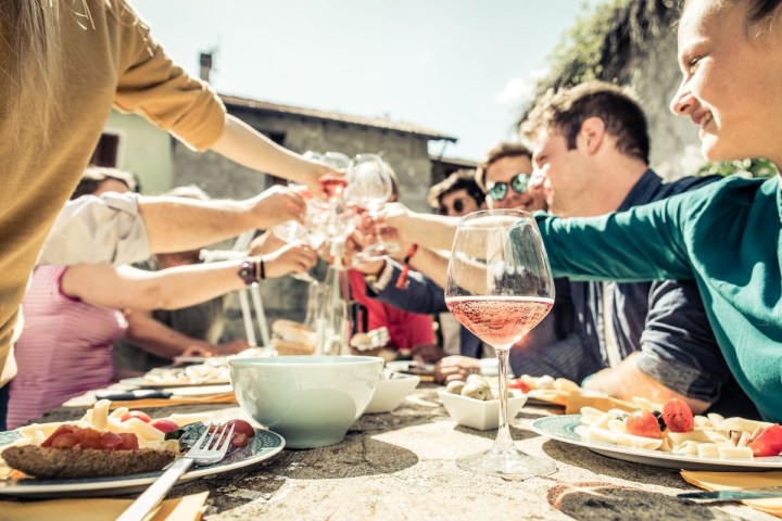 a group of people sitting at a table with a plate of food